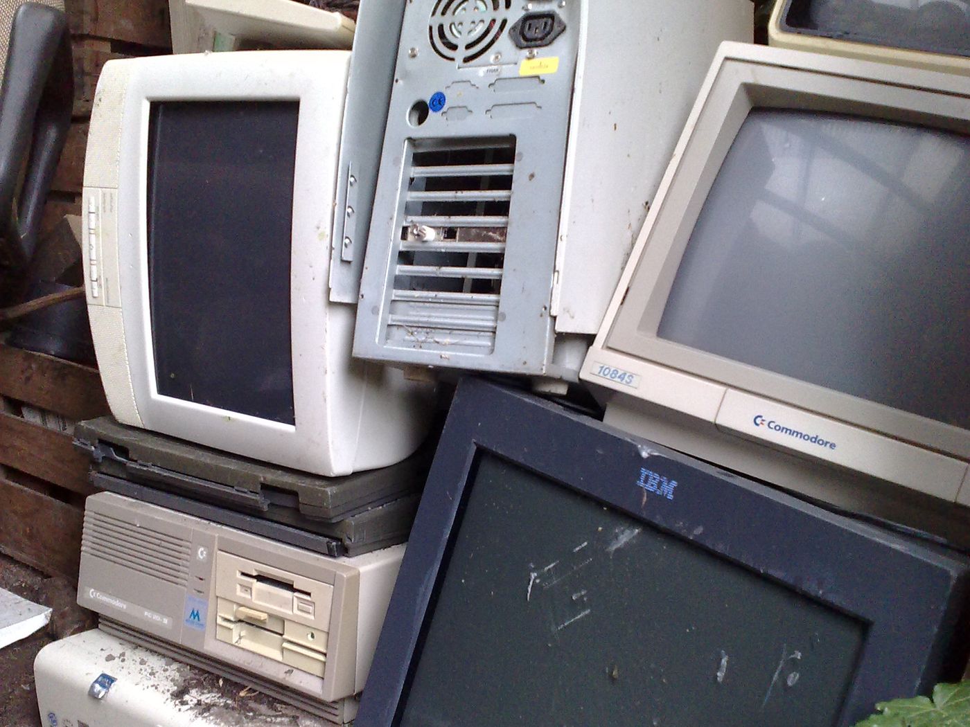A stack of old computers and CRT monitors awaiting recycling
